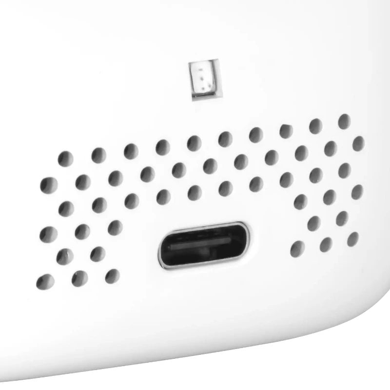 Close-up of a carbon monoxide detector with a grid pattern on a white background