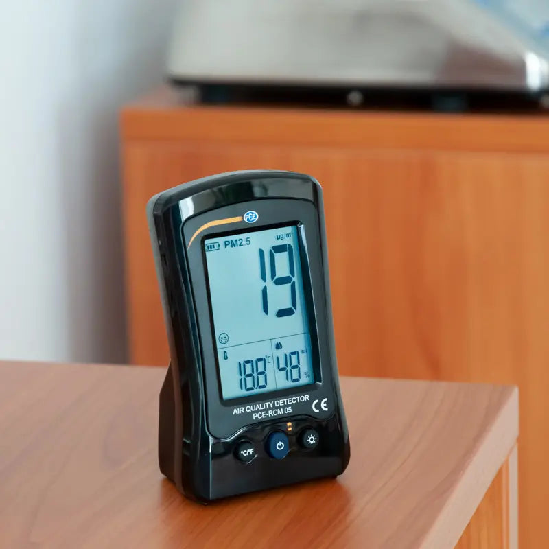 Air quality detector on a wooden surface with a blurred background