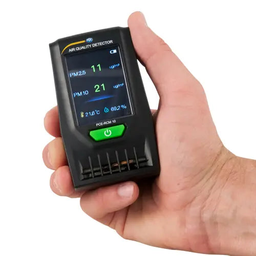 Hand holding a digital air quality detector with a white background