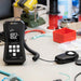 Light meter on a workbench with various tools and equipment in the background