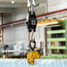 Digital hanging scale with a hook in an industrial setting