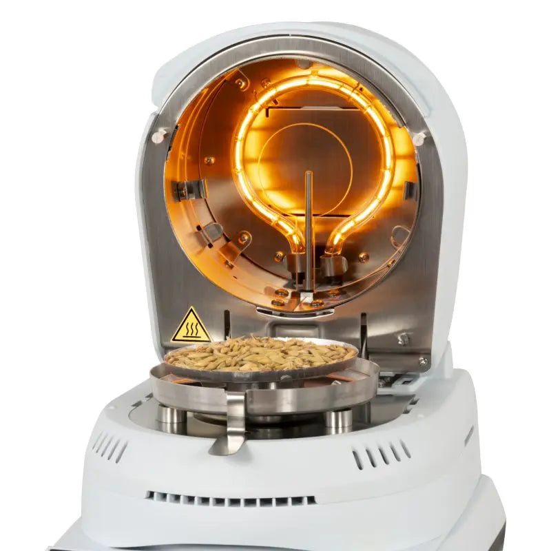 moisture analyzer with a clear chamber showing a sample.