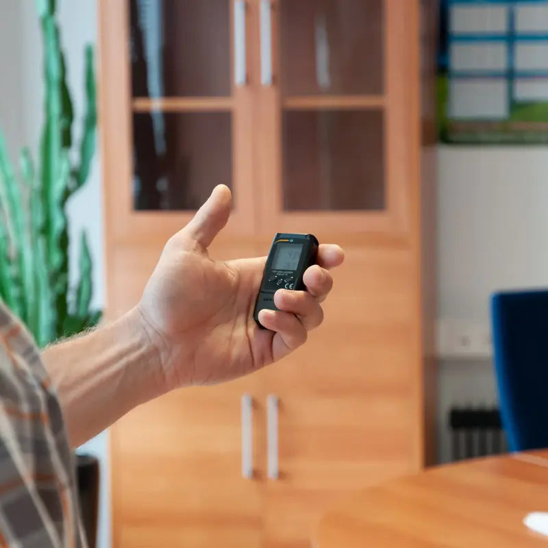someone holding a Data Logger
