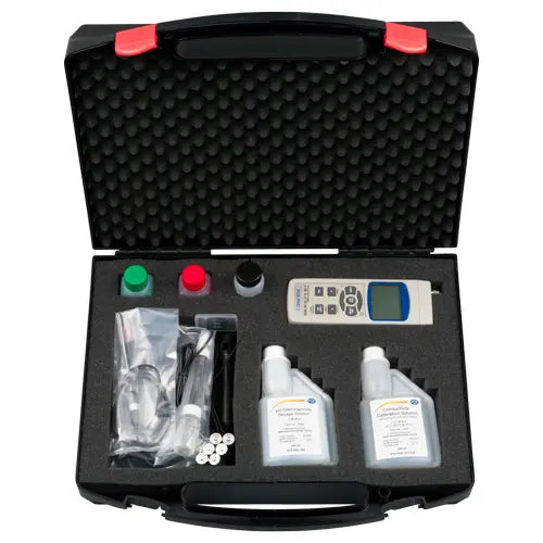 Open black tool case with various items including a digital device, bottles, and packaging on a white background.