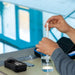 Person using a water quality tester with a clear background