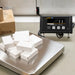 White boxes on a digital scale with a control panel in the background