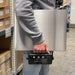 Person holding a scale in a warehouse setting
