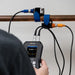 someone using an ultrasonic flow meter with sensors