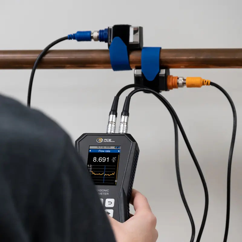 someone using an ultrasonic flow meter with sensors