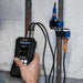someone using an ultrasonic flow meter with sensors