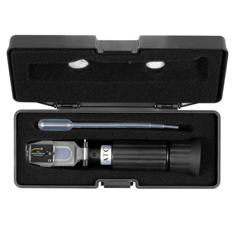 Brix refractometer in a black case on a white background