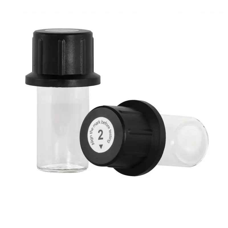 Clear glass vial with black cap on a white background