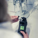 Person using a Turbidity Meter to measure a sample in a laboratory setting