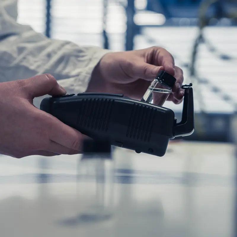 Person holding a Turbidity Meter with a blurred background