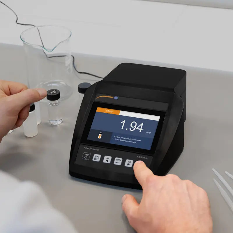 Turbidity Meter on a laboratory counter with a person interacting with it