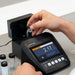Person using a Turbidity Meter with a screen to measure something, likely a lab or medical setting.