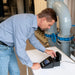 Man working with a Turbidity Meter on a table in an industrial setting