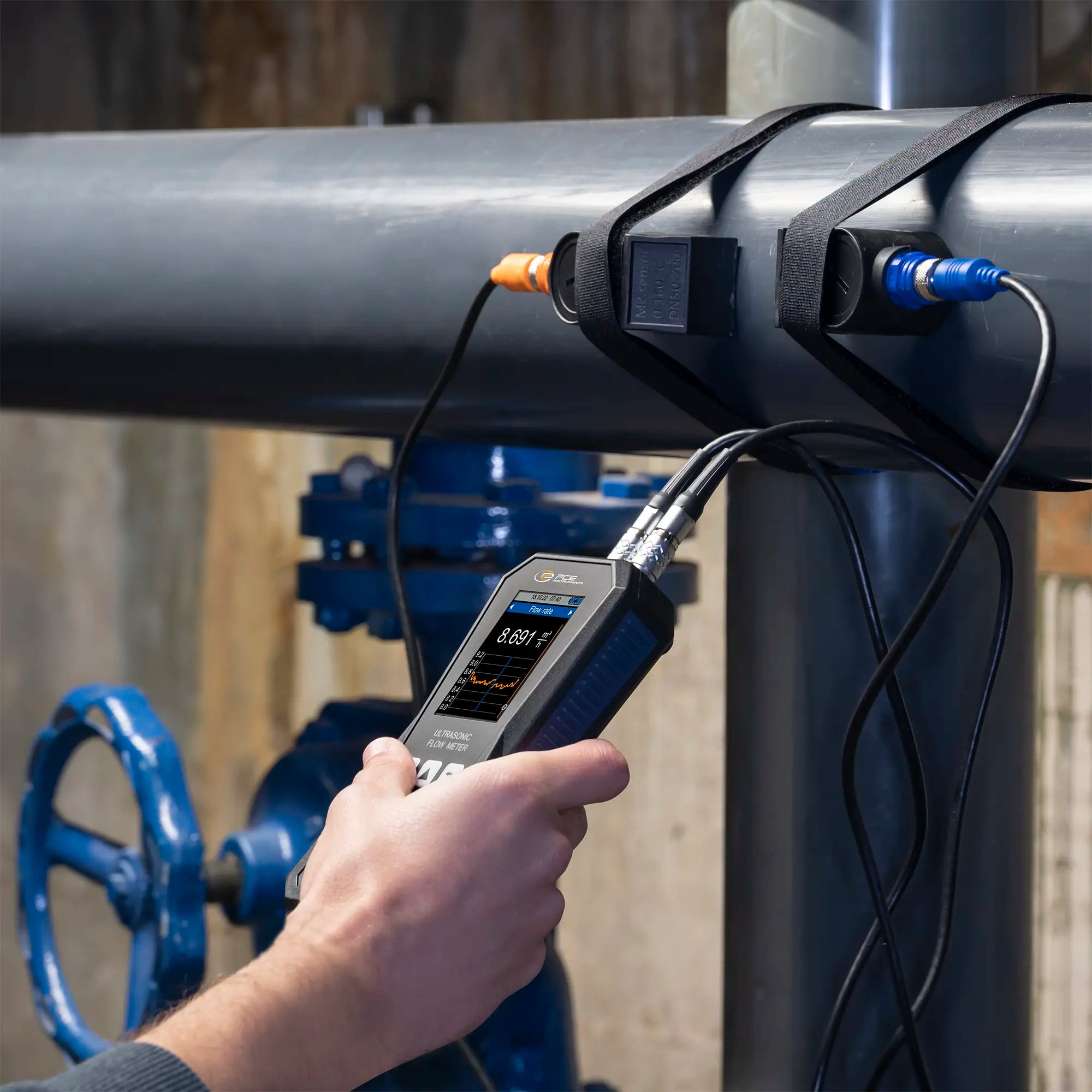 someone using an ultrasonic flow meter with sensors