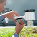 Person adjusting a device on a pole outdoors